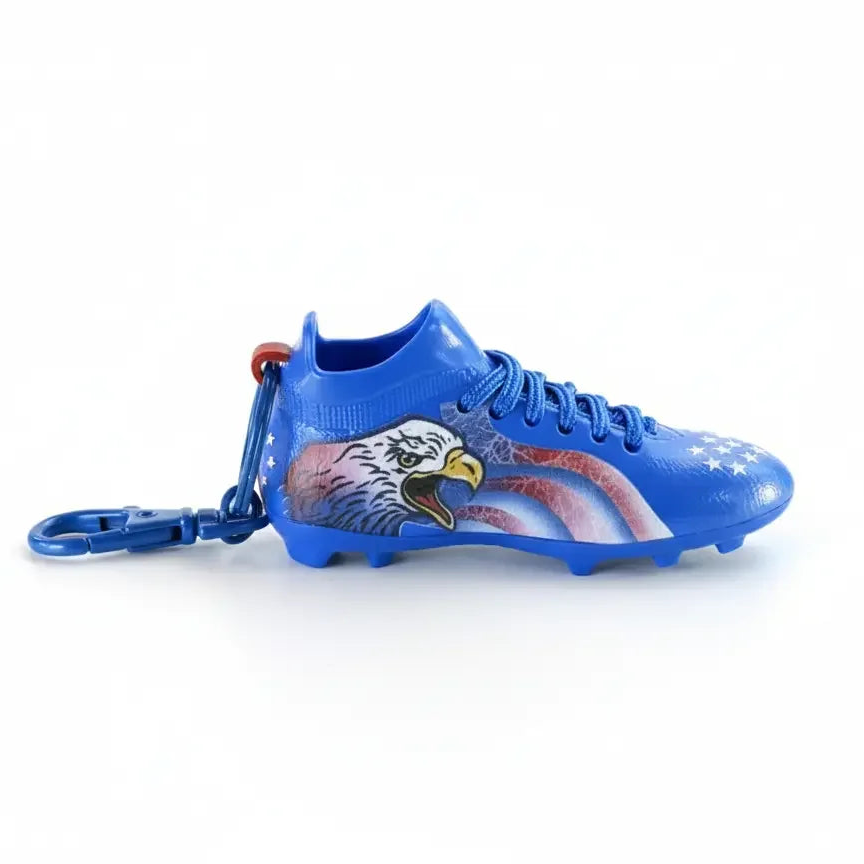 Miniature blue soccer shoe keychain with eagle and American flag design, collectible charm
