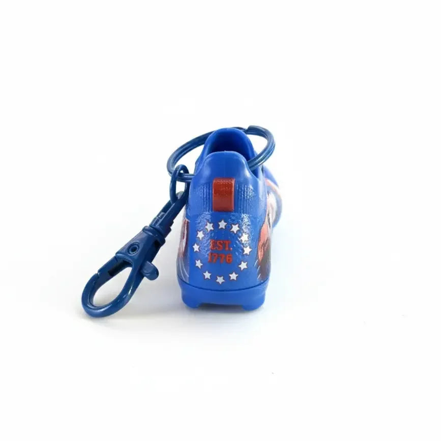 Blue miniature soccer shoe keychain with USA patriotic stars and EST. 1776 design, bag charm